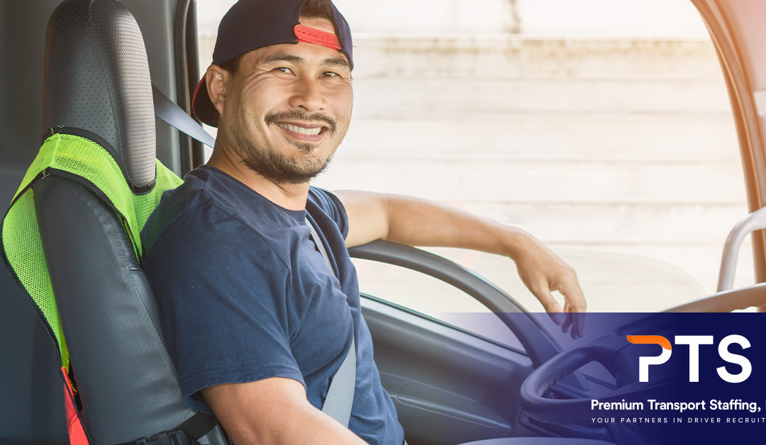 Hispanic truck driver sitting in the driver's seat smiling