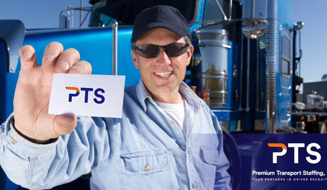 truck driver holding up a PTS business card and smiling